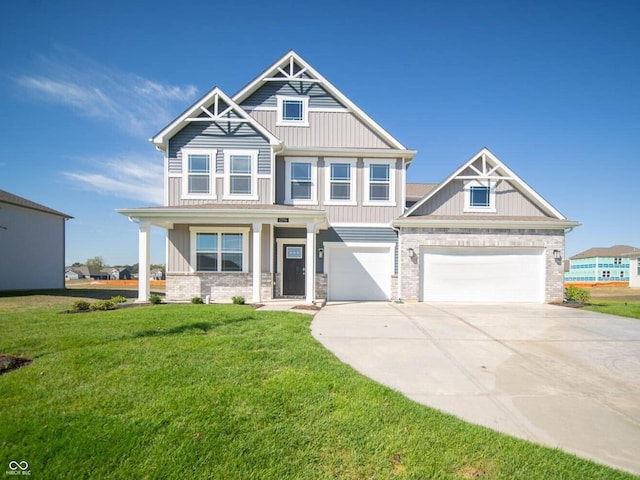 craftsman house featuring brick siding, board and batten siding, a porch, a front yard, and driveway