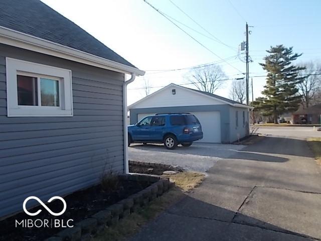 view of property exterior featuring an outdoor structure and a garage