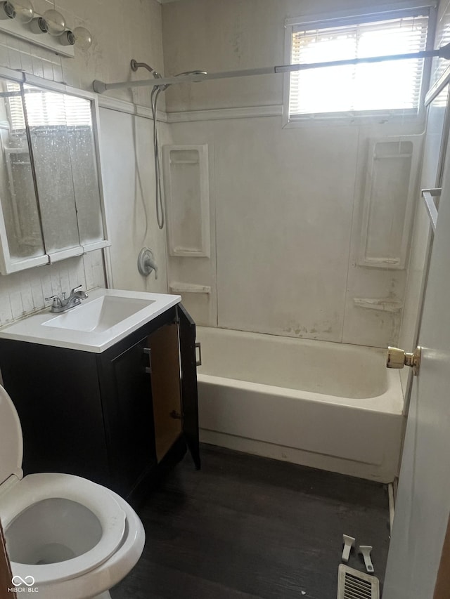 full bath with toilet, vanity, shower / bath combination, and wood finished floors