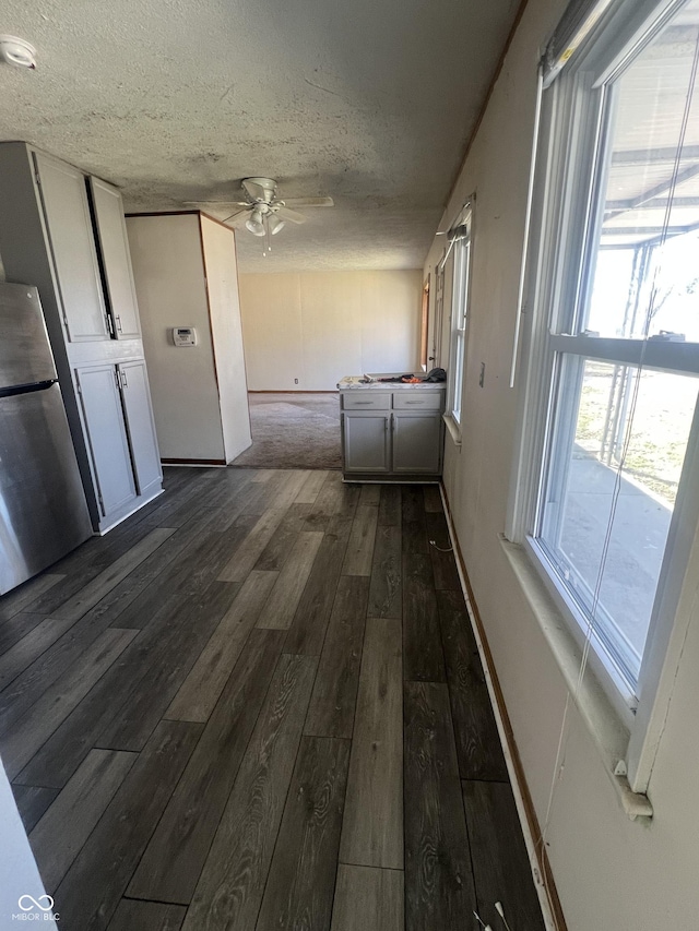 interior space with a textured ceiling and dark wood finished floors