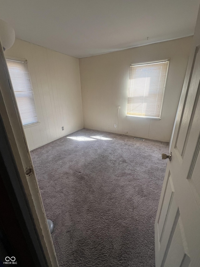 unfurnished bedroom with visible vents and carpet floors