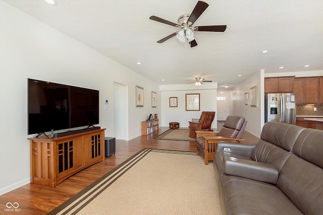 living room featuring recessed lighting, a ceiling fan, baseboards, and wood finished floors