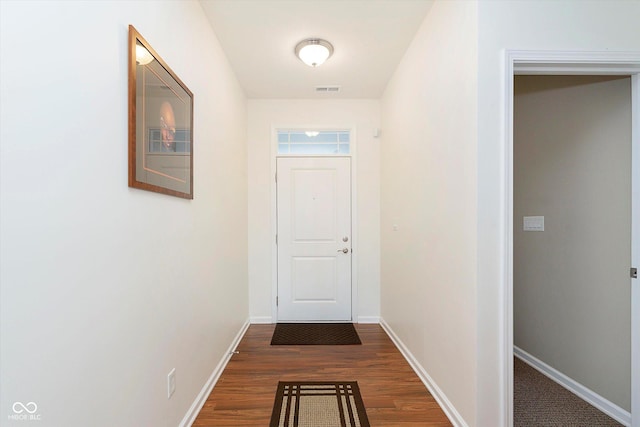 entryway with dark wood finished floors, visible vents, and baseboards