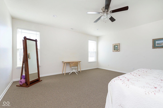 carpeted bedroom featuring baseboards and a ceiling fan