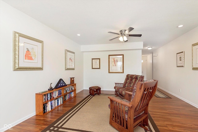 living area featuring a ceiling fan, recessed lighting, wood finished floors, and baseboards