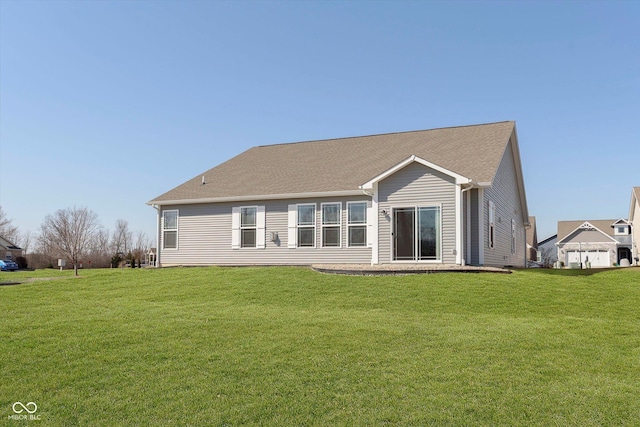 back of house with a lawn