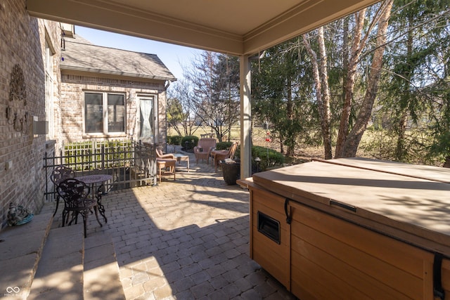 view of patio / terrace with a hot tub