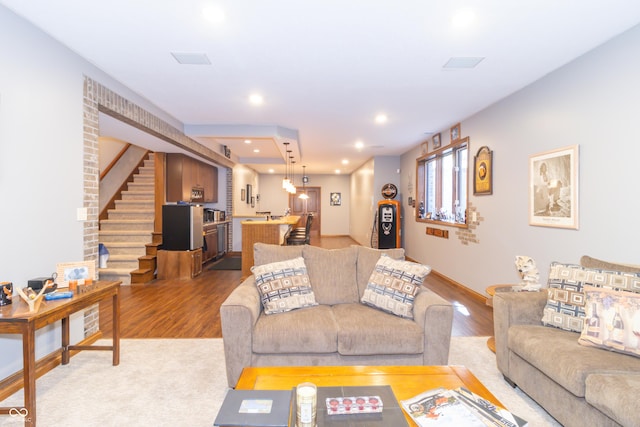 living area featuring stairs, recessed lighting, light wood-style floors, and baseboards