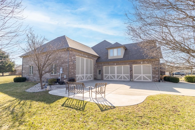 rear view of house featuring driveway, roof with shingles, an attached garage, a yard, and brick siding