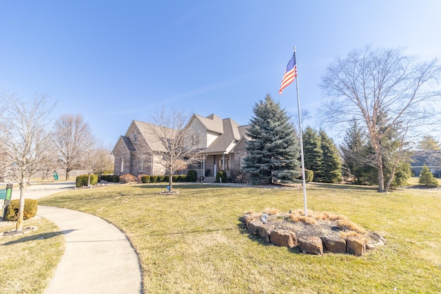 view of front of property with stone siding and a front lawn