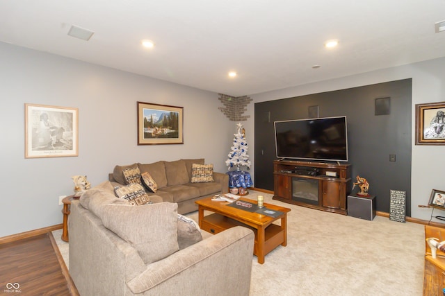 living area featuring recessed lighting and baseboards