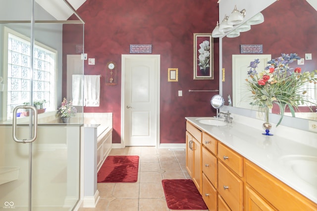 full bathroom featuring a sink, tile patterned flooring, double vanity, baseboards, and a bath