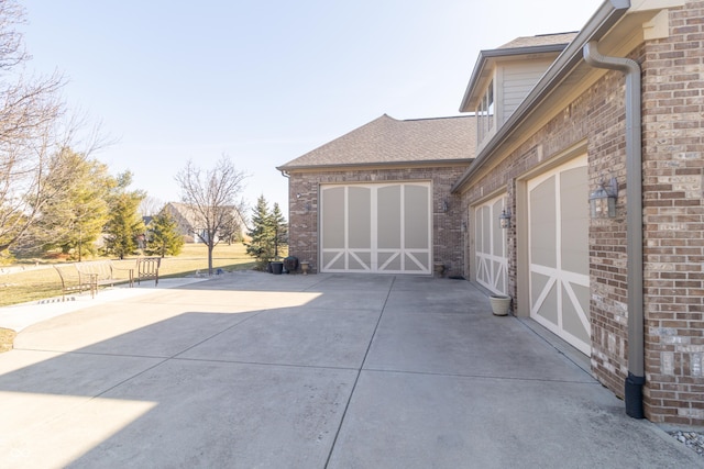 view of patio featuring a garage and driveway