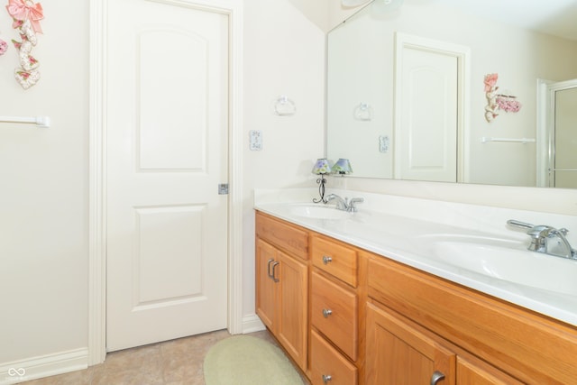 full bathroom with double vanity and a sink