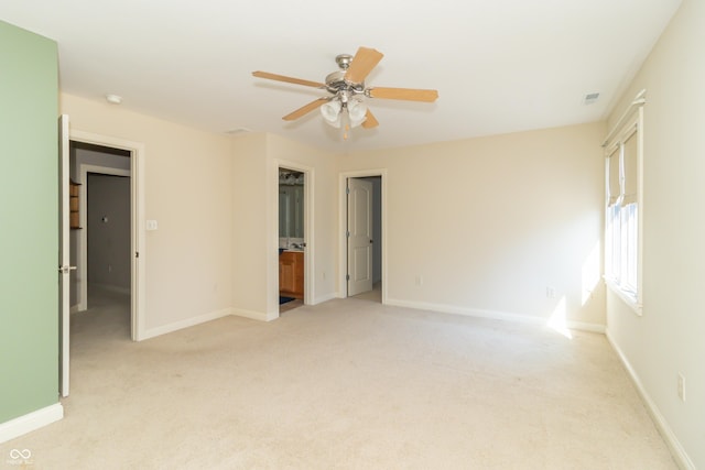 unfurnished bedroom with baseboards, light carpet, and ceiling fan