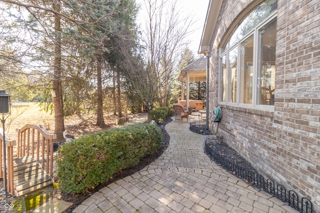 view of patio / terrace with a hot tub