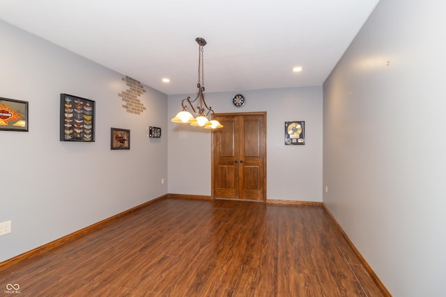 spare room featuring recessed lighting, dark wood-style floors, and baseboards