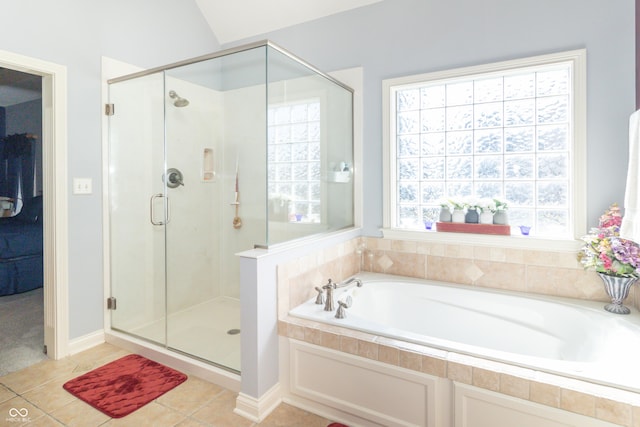 bathroom with tile patterned floors, a bath, and a shower stall