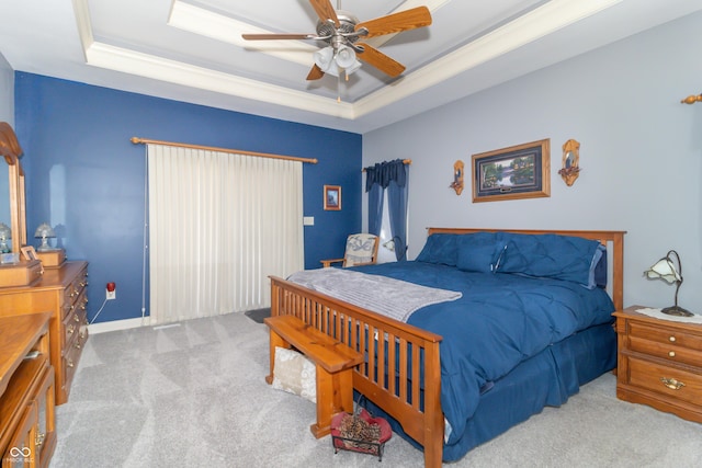 bedroom with a raised ceiling, a ceiling fan, and carpet floors