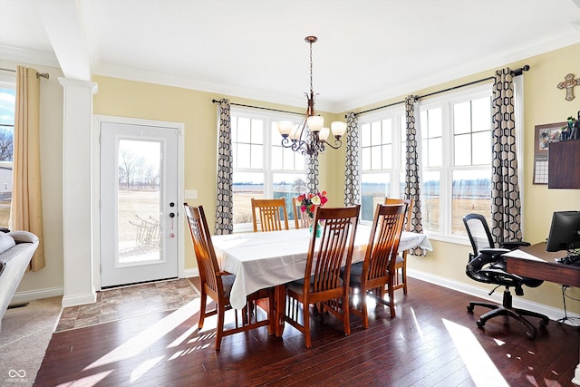 dining space featuring hardwood / wood-style floors, baseboards, and ornamental molding