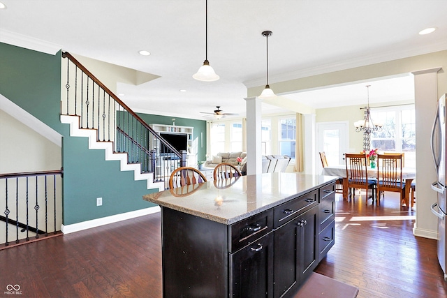 kitchen with dark wood-type flooring, crown molding, and baseboards