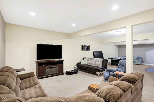 carpeted living area with a glass covered fireplace, recessed lighting, and baseboards