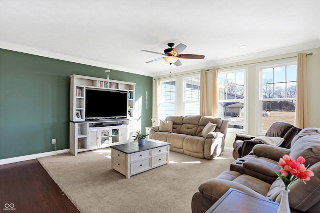 living area with ceiling fan, crown molding, and baseboards