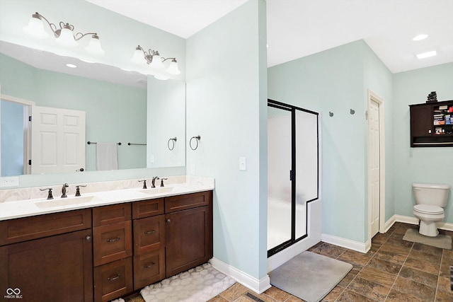 full bath featuring double vanity, a stall shower, and a sink