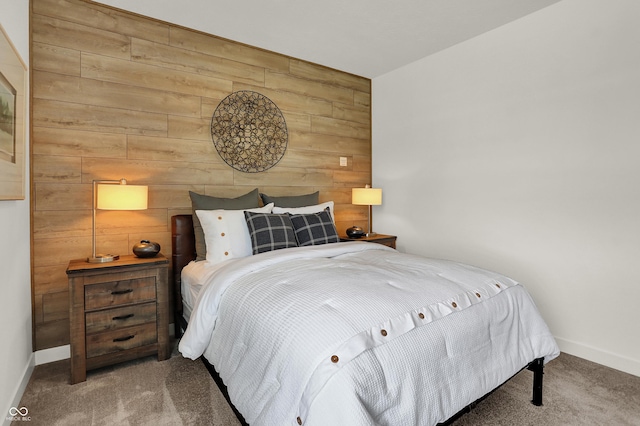 carpeted bedroom featuring wooden walls and baseboards