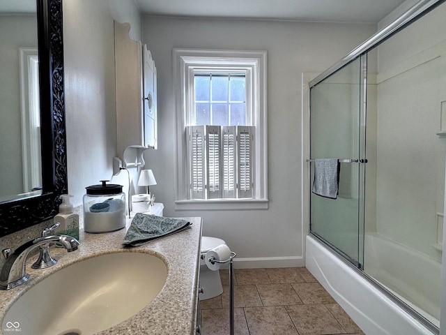 bathroom with tile patterned flooring, baseboards, toilet, combined bath / shower with glass door, and vanity