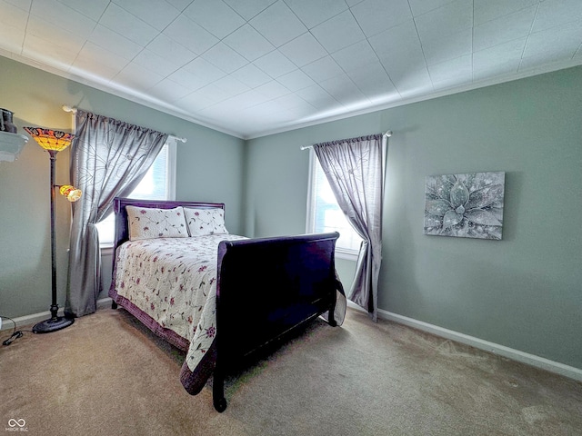 bedroom featuring multiple windows, baseboards, and carpet floors