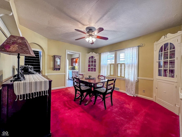 dining area with baseboards, carpet flooring, a textured ceiling, and ceiling fan