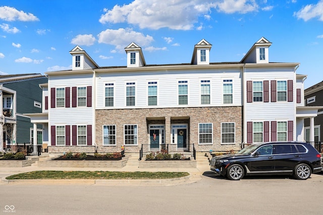 view of property featuring stone siding