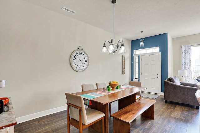 dining room with visible vents, baseboards, dark wood finished floors, a chandelier, and a textured ceiling