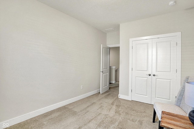 sitting room with light colored carpet and baseboards