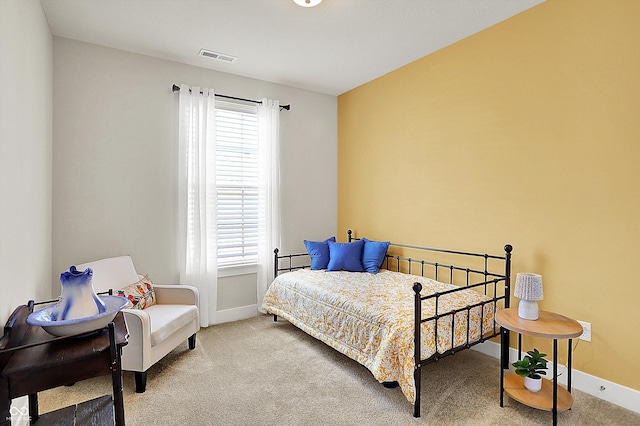 bedroom with visible vents, carpet, and baseboards