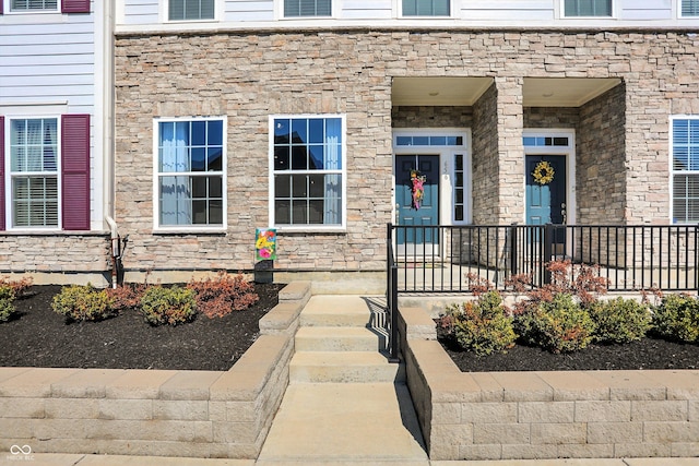 property entrance featuring stone siding