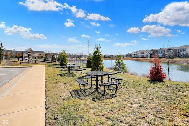 view of home's community with a yard, a residential view, and a water view