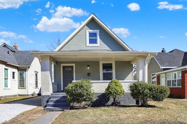 bungalow with brick siding and a porch