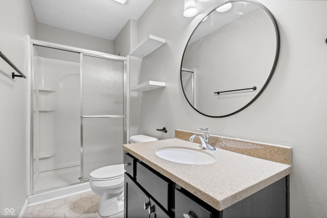 bathroom featuring vanity, tile patterned flooring, a shower stall, a textured ceiling, and toilet