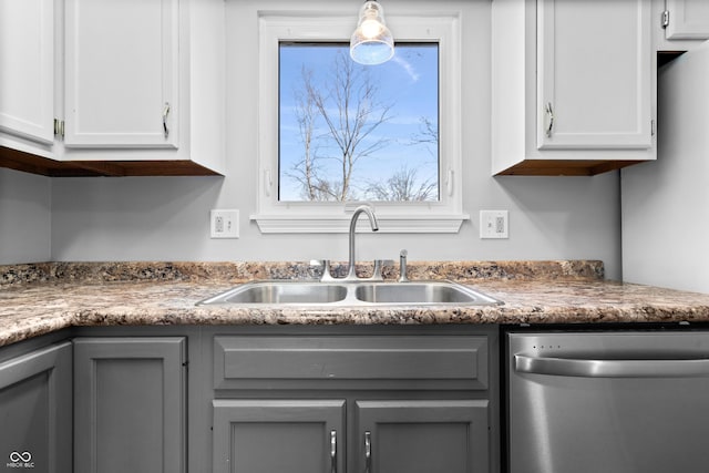 kitchen featuring gray cabinets, dishwasher, white cabinets, and a sink