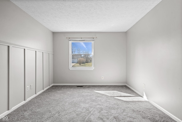 unfurnished bedroom with carpet flooring, baseboards, a closet, and a textured ceiling