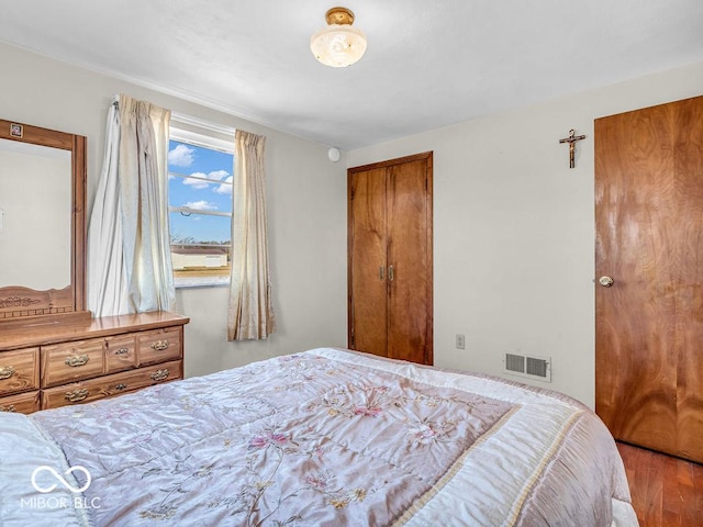 bedroom with wood finished floors and visible vents