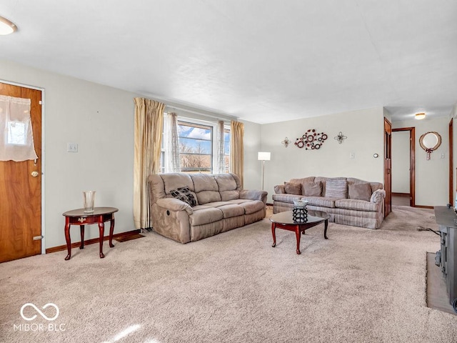 carpeted living room featuring baseboards