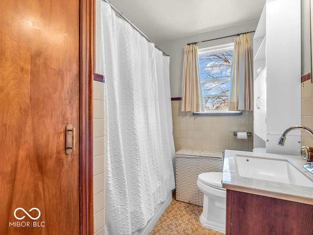 bathroom featuring vanity, tile walls, curtained shower, and toilet