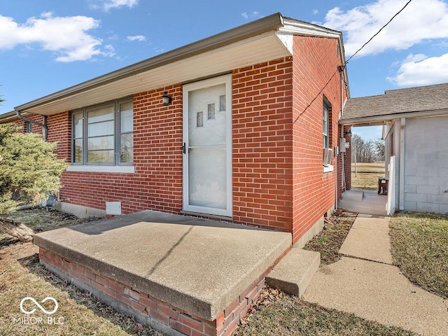 entrance to property featuring brick siding