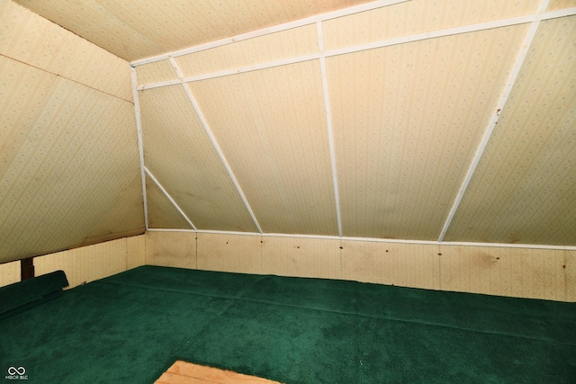 bonus room featuring wallpapered walls and lofted ceiling