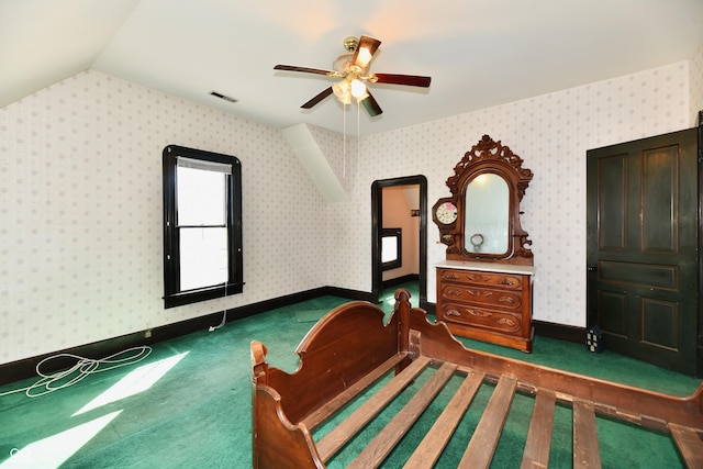 carpeted bedroom with wallpapered walls, lofted ceiling, and visible vents