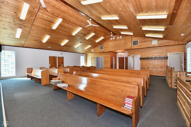 carpeted dining area with a wealth of natural light, wooden walls, wooden ceiling, and visible vents