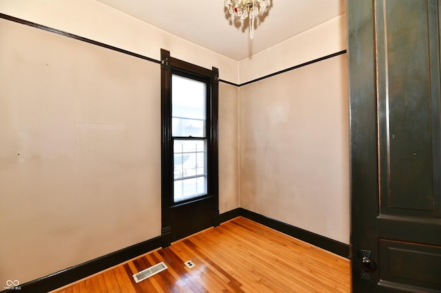 interior space with visible vents, baseboards, and wood-type flooring